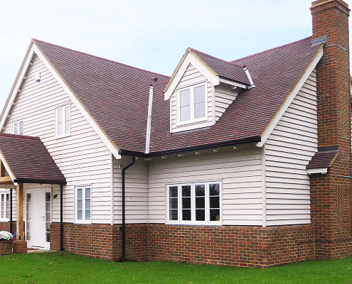 Black moulded ogee gutters on country homes