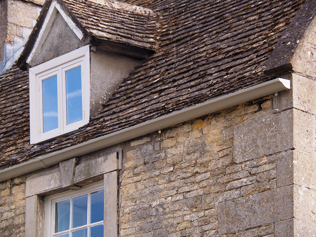 Cream powder coated aluminium victorian ogee guttering fitted to period property