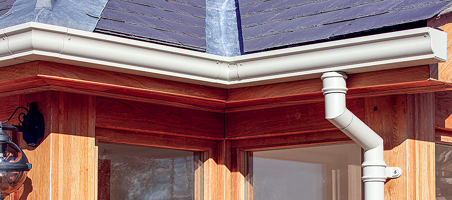 Cream moulded ogee gutters and traditional cast round swan neck