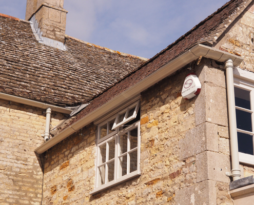 cream victorian ogee guttering and traditional round cast downpipes