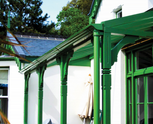 green aluminium victorian ogee gutters with traditional cast downpipes