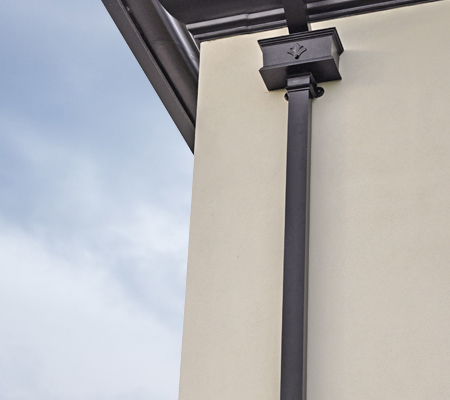 guttercrest aluminium ornate hopperhead in black with moulded ogee guttering and georgian square cast downpipes