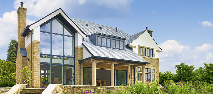 Round smoothline downpipes and beaded deep flow gutters fitted to residential property