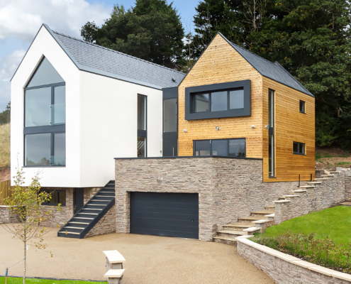 Aluminium primary fascia, combined fascia soffits, copings and window casements fitted to modern residential build.