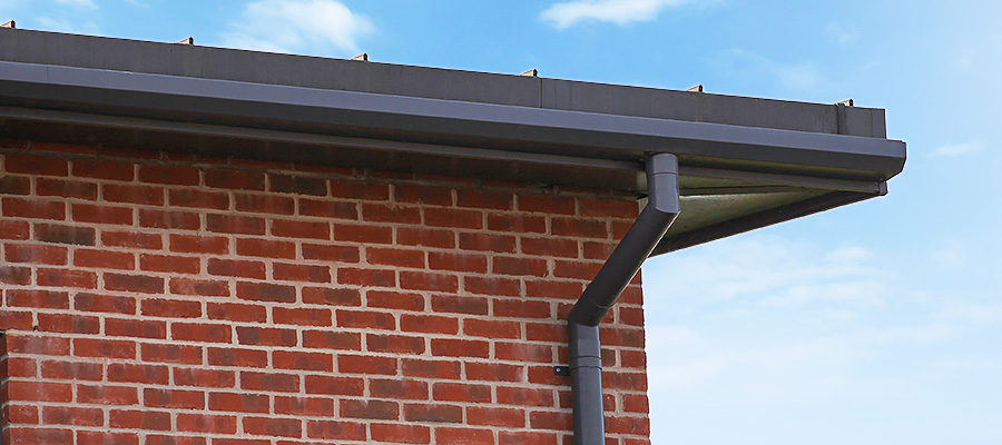 Aluminium shaped box guttering with round downpipe and two piece swan neck