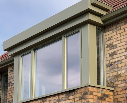 Pale Green Aluminium Guttering with Integrated Fascia & Window Detailing | Guttercrest