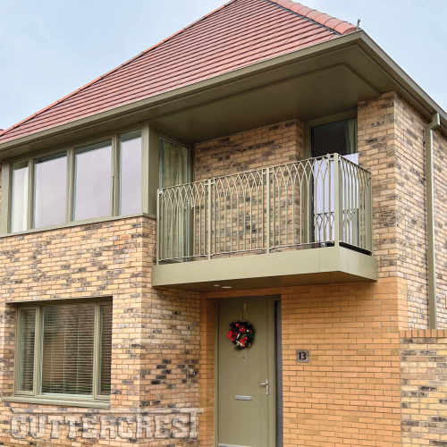 Modern Brick Building with Green Balcony, Soffits &amp; Door | Guttercrest