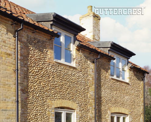 Half round gutter with traditional round downpipe in heritage black finish
