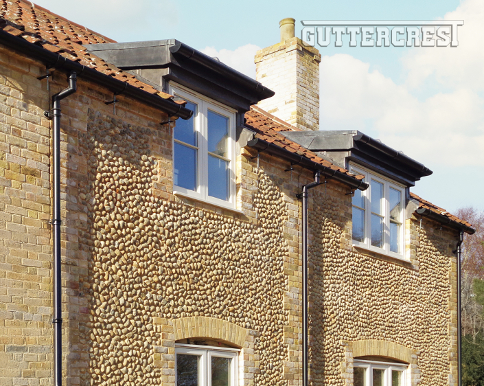 Heritage black half round gutter and round downpipe system Half round gutter with traditional round downpipe in heritage black finish