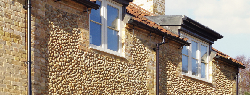Half round gutter with traditional round downpipe in heritage black finish